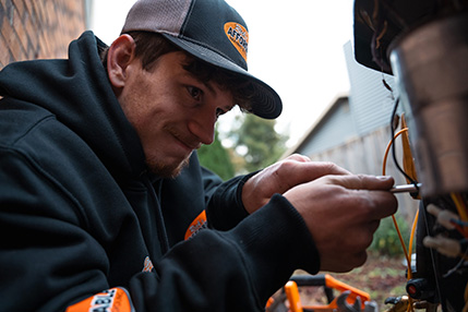 Rick's HVAC technician servicing a system in Toledo