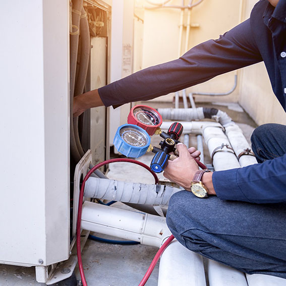 Ricks Affordable Heating & Cooling technician servicing heat pump