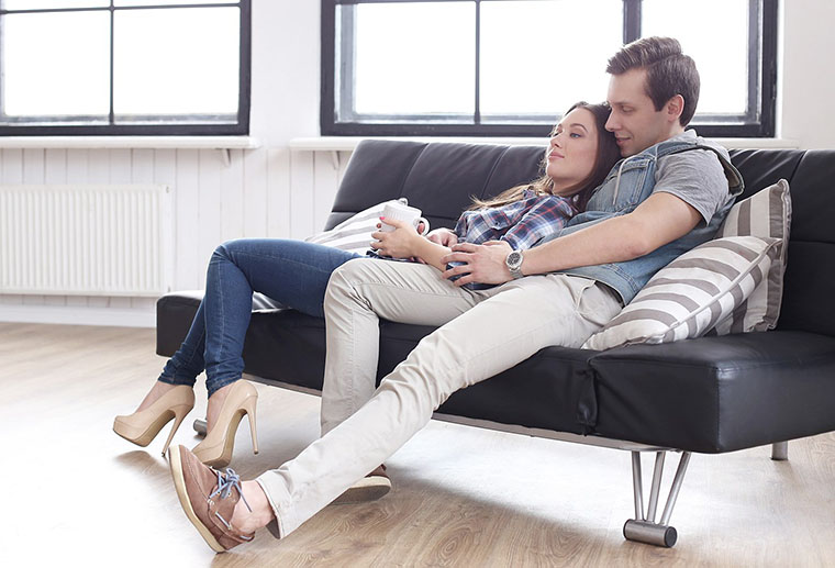 Couple enjoying warm house with a heat pump replacement by Ricks Affordable Heating & Cooling