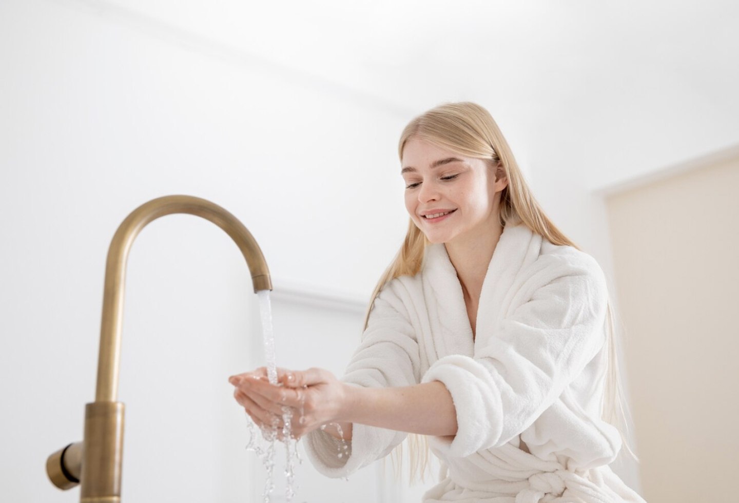 Woman enjoying warm water after water heater repair by Ricks Affordable Heating & Cooling