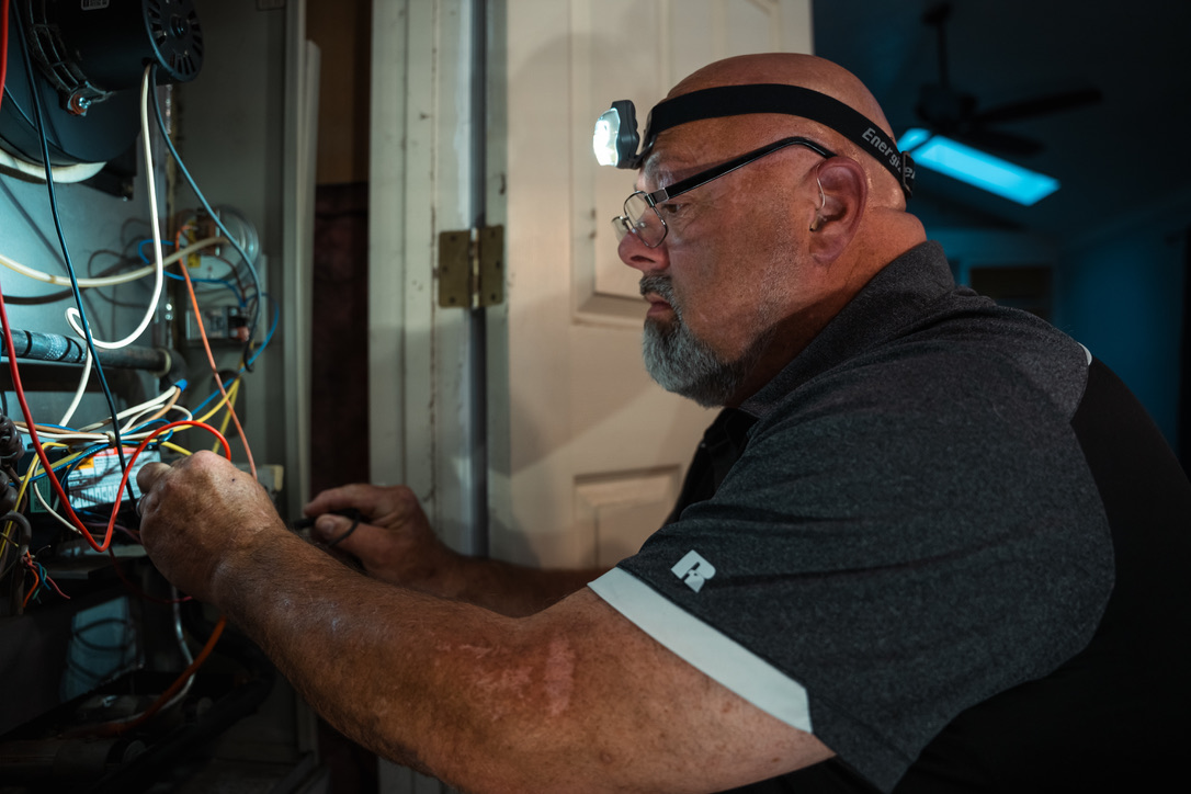 Rick's Affordable technician performing furnace maintenance