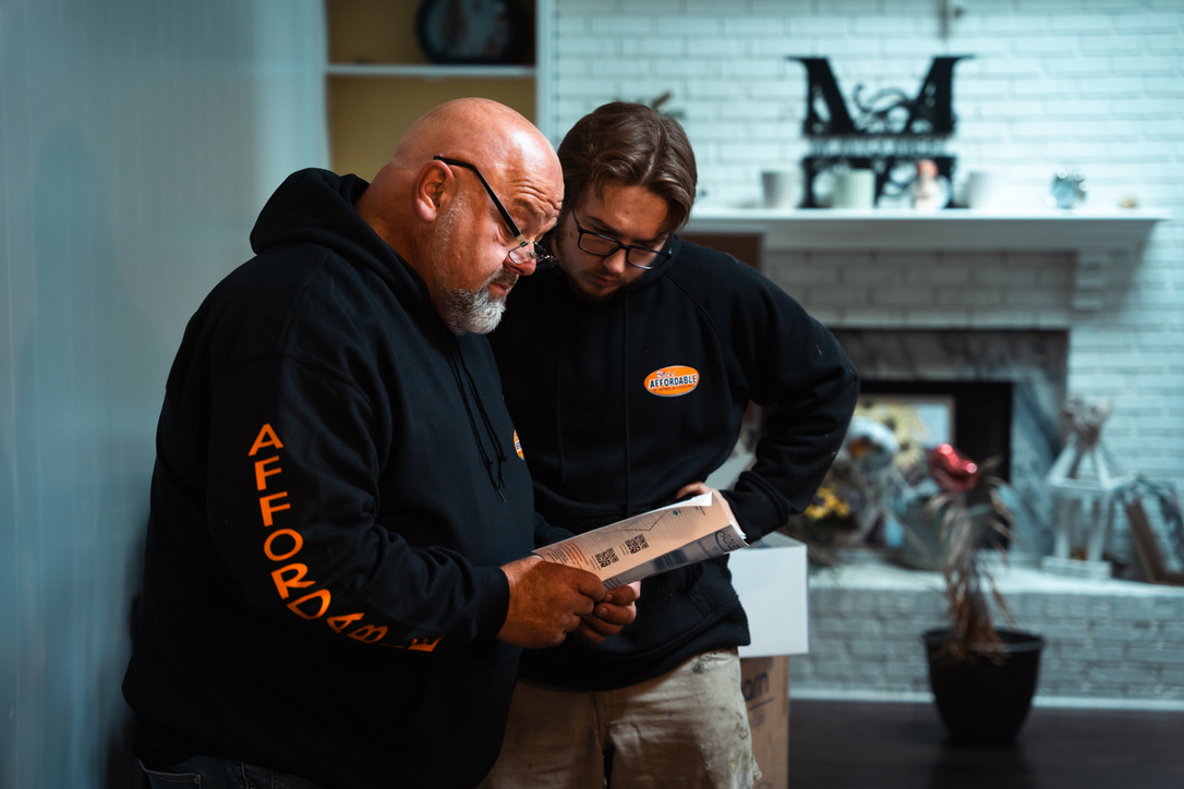 Rick's HVAC technicians discussing air quality solutions in Toledo Ohio