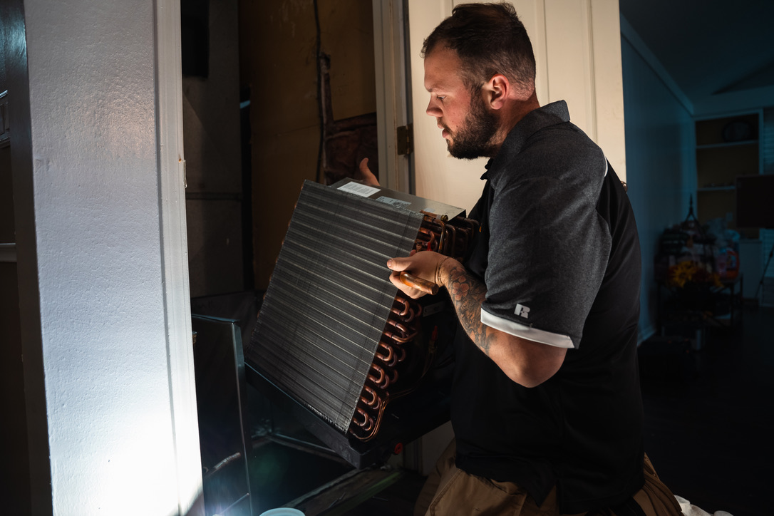 Rick's Affordable technician installing evaporator coil during heat pump conversion
