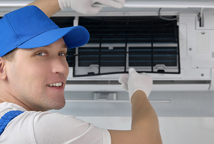 Rick's Affordable Heating & Cooling technician performing air conditioning installation in Perrysburg, Ohio