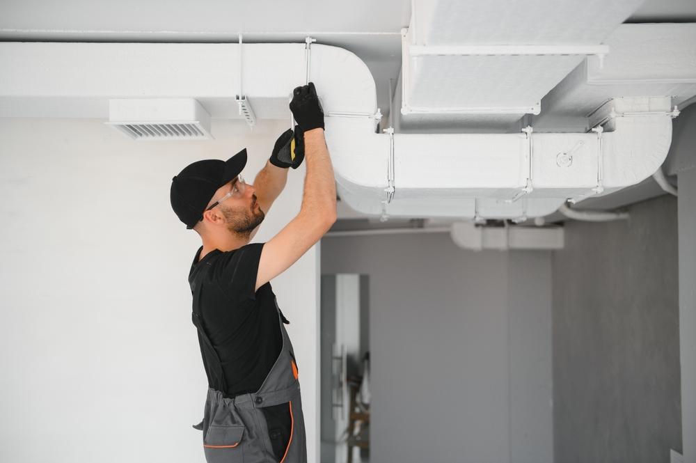Hvac worker working on an air duct