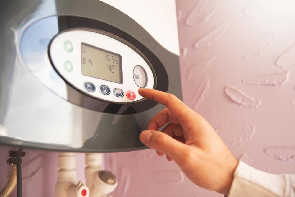 What Are the Pros and Cons of Tankless Water Heaters? 1 A readout on a tankless water heater.