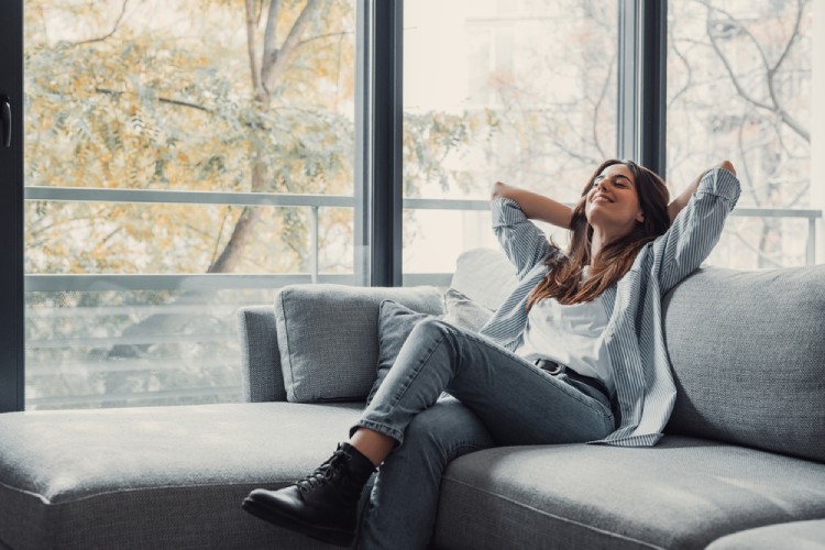 A young woman enjoying clean air in a modern room.